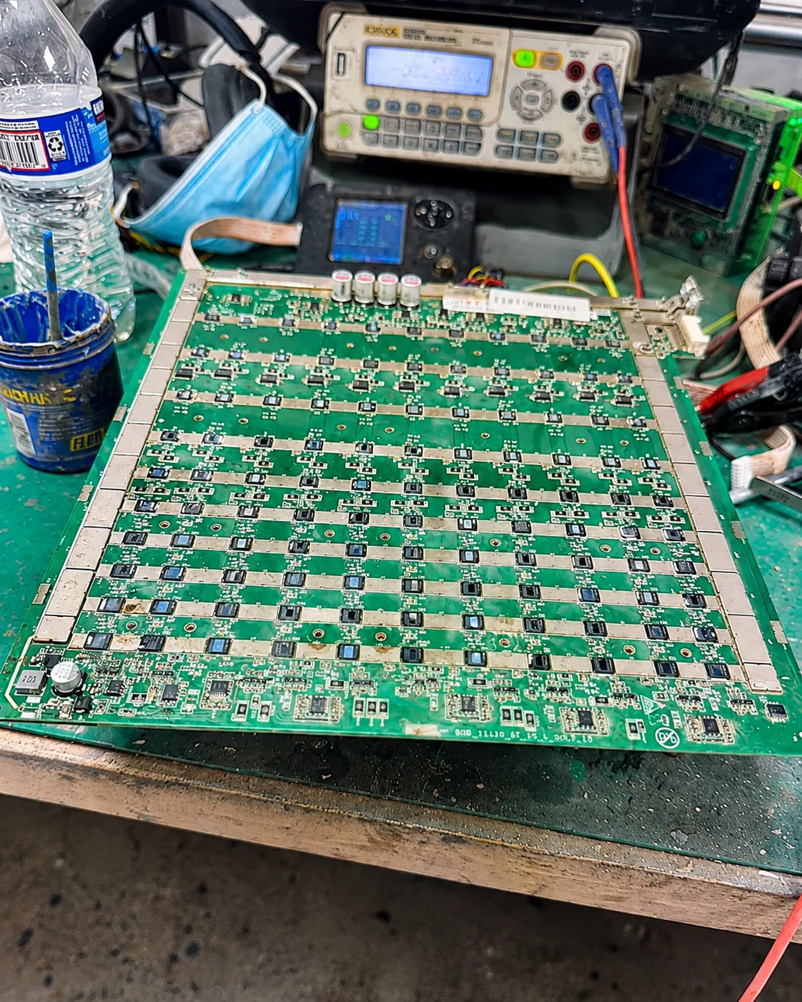 ASIC hashboard diagnostics and repair tools on electronics workbench