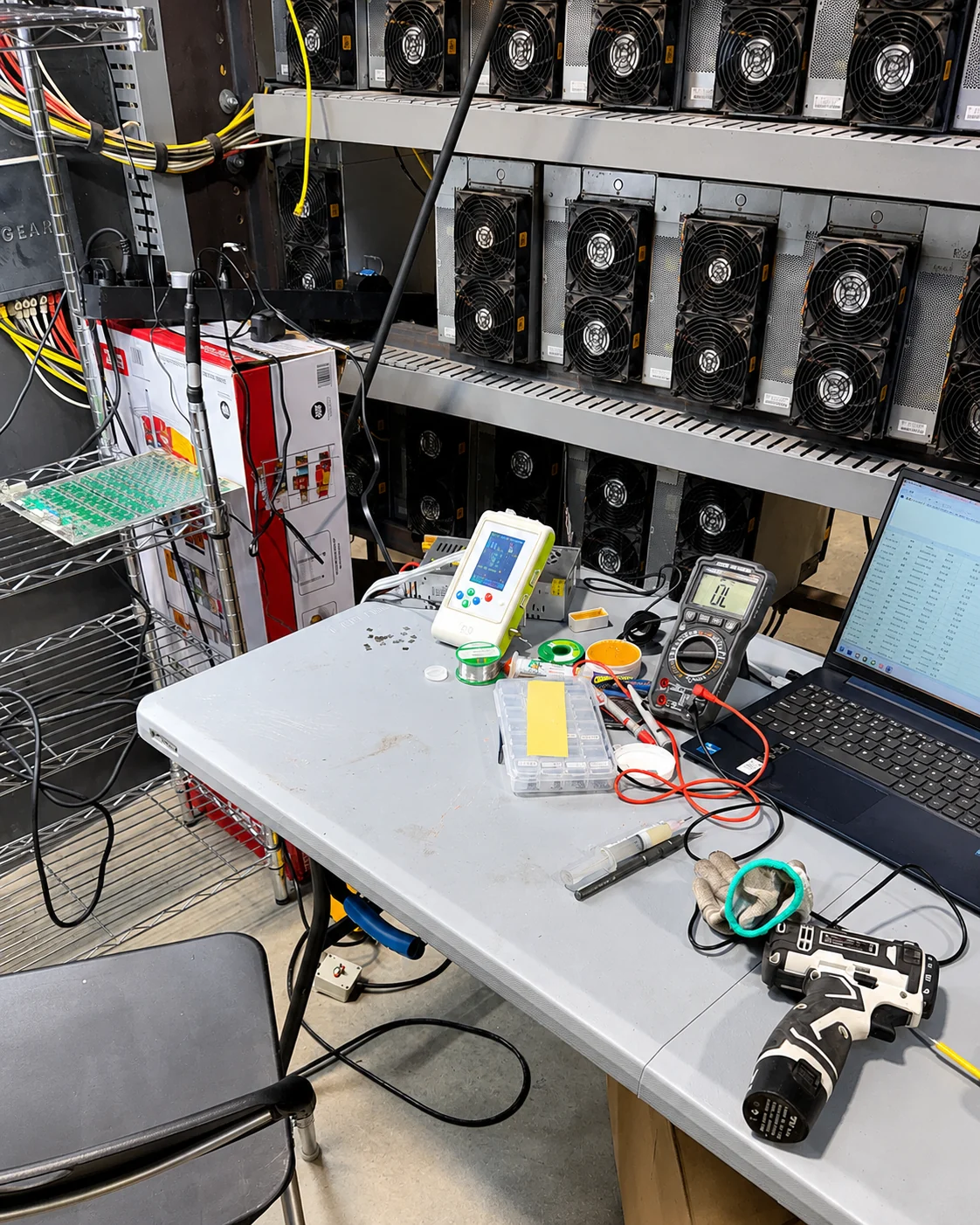 ASIC miner repair workbench with diagnostic equipment and hashboards